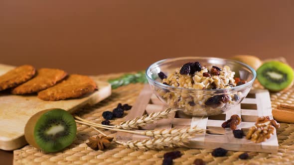 Woman Adding Raising and Apples To a Porridge alt