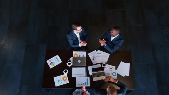 Business people in suits handshake and completing a meeting in a modern office building alt