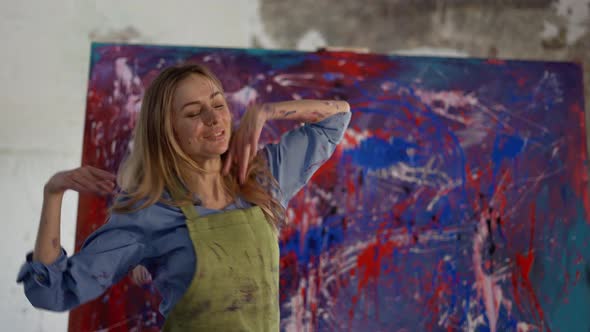 Woman Funny Dancing in Front of Abstract Painting in Studio in Slowmo alt