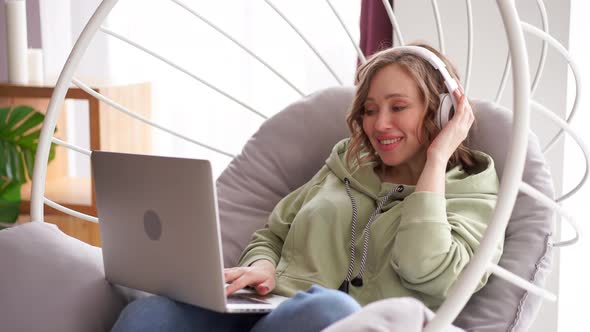 Happy Smile Woman Listen Music Headphones Use Laptop Typing Text Message on Laptop While Sitting alt