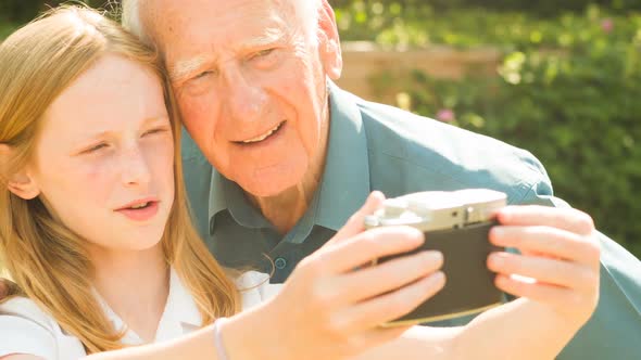 Elderly man and his Grand Daughter taking selfies