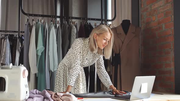 Portrait of Young Caucasian Designer Woman Using Laptop alt