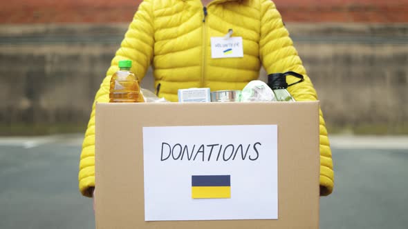 Volunteer Collecting Box with Donations for Ukrainian Refugees  Humanitarian Aid for Ukraine alt