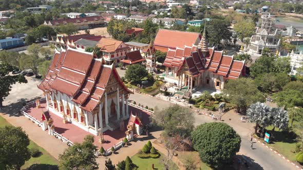 Fly-over survey view of Chalong Temple grounds and shrines in Phuket, Thailand alt