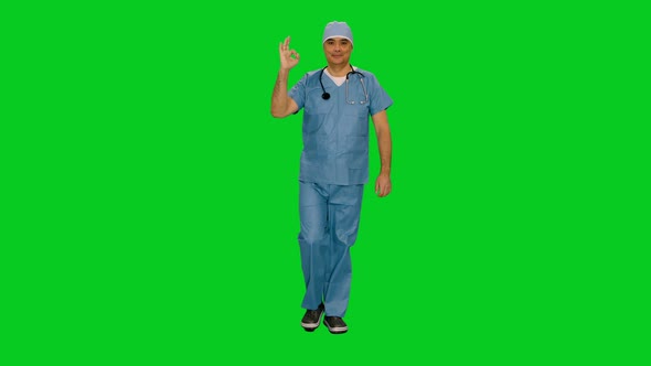 Doctor in Uniform Shows Ok Sign and Smiling while Walking on Green Screen 