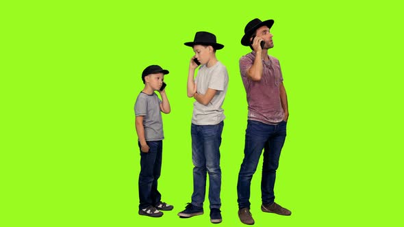 Father and Two Sons Talking on Mobile Phones  All at Once