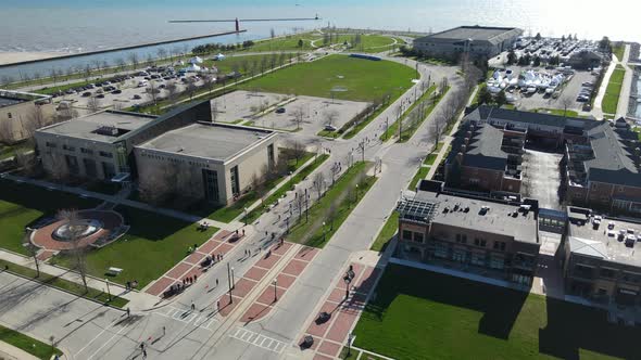 Drone view of Lake Michigan harbor, Kenosha, Wisconsin. Groups of people running in the street.