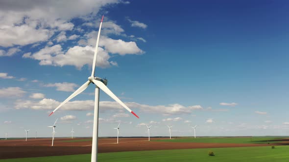 Wind Turbine Power Generator Farm at Beautiful Pure Blue Sky and Green Grass Background