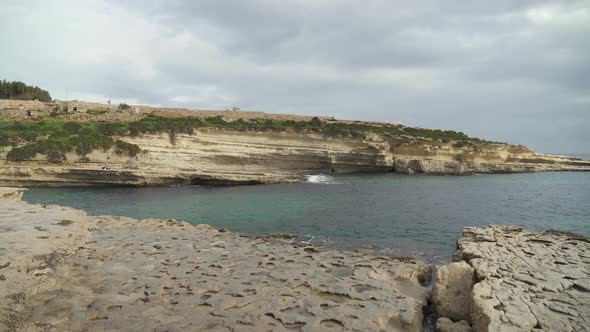 Panorama of Long and Remote Stone Beach Il-Kalanka in Malta
