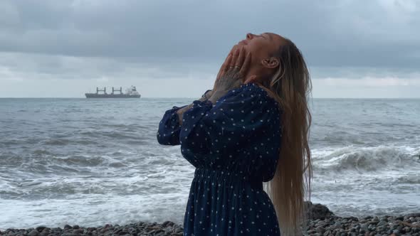 Happy Girl Enjoying the Rain at the Sea Coast