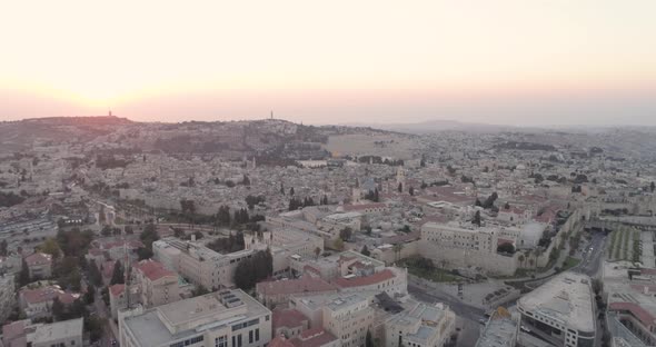 Fly down twilight hour, red sunset over Jerusalem city, aerial view, drone. alt