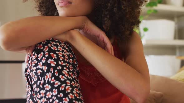 Portrait of african american woman sitting on bed smiling alt