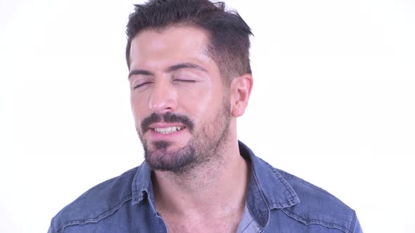 Face of Happy Young Bearded Hipster Man Relaxing with Eyes Closed alt