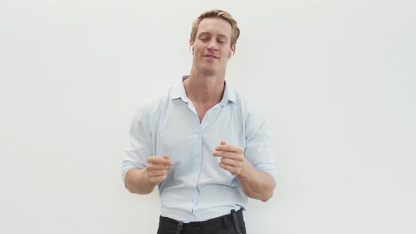 Man Listens to Music with Wireless Headphones Dances Moves His Head to Beat alt