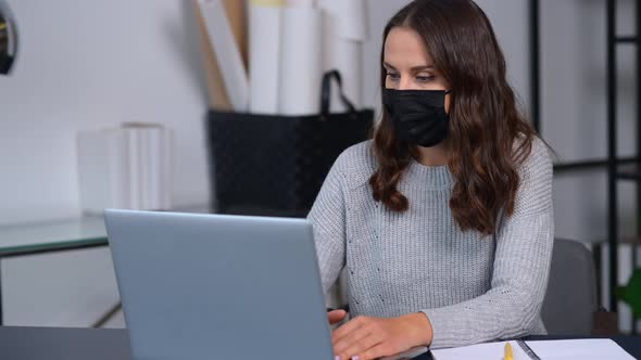 Female Employee Stays in Safety Against Viral Diseases Working in the Office alt