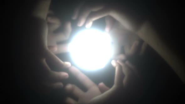 Hands together holding light