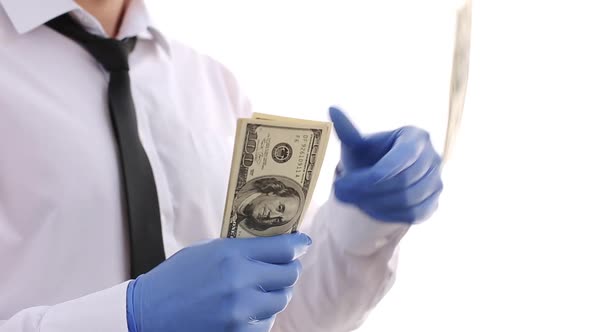 Banker Scatters Dollars During The Covid 19 Quarantine With Gloves. 