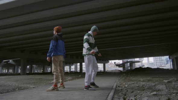 Two Guys Performing Epic Parkour Stunt on Street alt