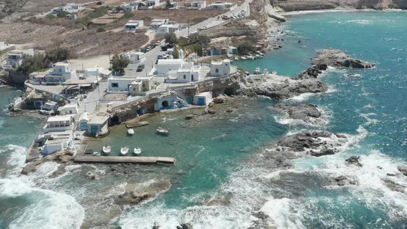 Wide Establishing Shot of Greek Fishing Village Build Right By the Ocean with Beautiful Turquoise alt