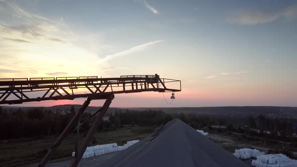 Outdated Mining Sector Elements Against Orange Sky alt