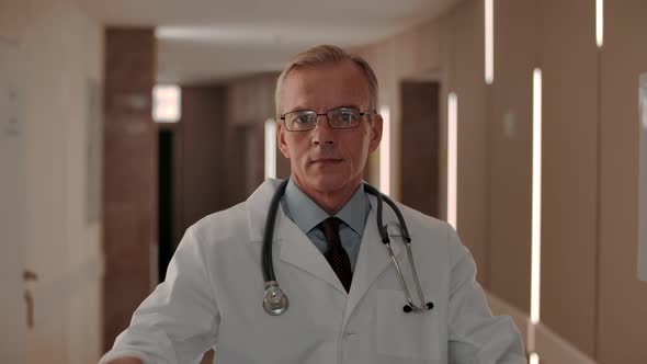 Portrait of a Smart Confident Therapist Putting on Glasses alt