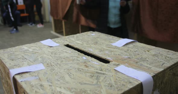 Unidentifiable person casting a ballot during elections