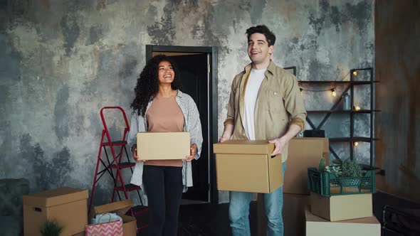 Young Multiracial Couple is Moving Into New Apartment alt