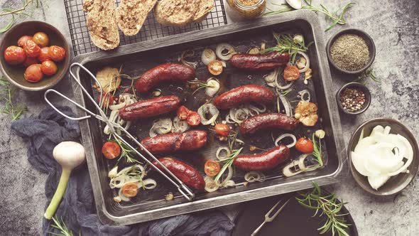 Tasty Grilled Homemade Rosemary Sausages Placed on Iron Frying Tray Over Rustic Dark Stone Table alt