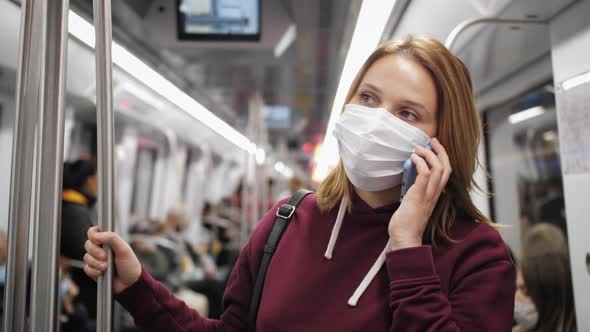 Passenger Wearing Protective Mask Having Phone Conversation on Metro Subway alt