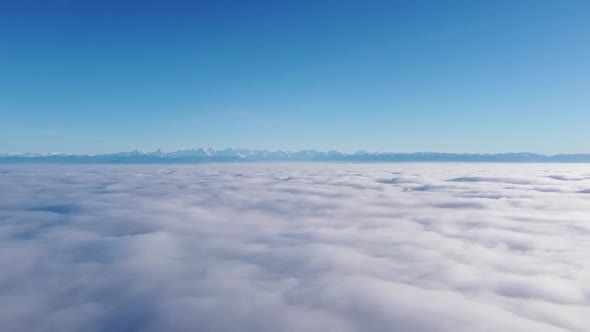 wonderful flight with the drone over a breathtaking sea of ​​fog towards the majestic swiss alps in alt