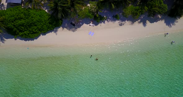 Beautiful fly over tourism shot of a summer white paradise sand beach and aqua blue ocean background alt