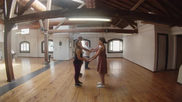 People in Pairs Standing Against Each Other in Dance Studio alt