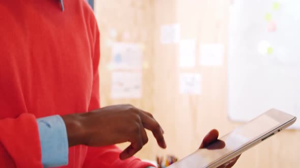 Man using digital tablet in office alt