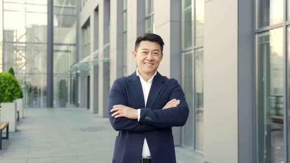 portrait young confident successful asian businessman looking at camera.  alt