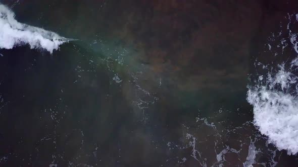 Aerial view looking down at waves on the ocean alt