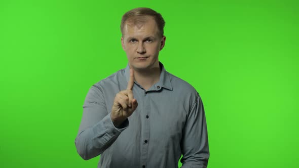Guy Warning with Admonishing Finger Gesture, Saying No, Be Careful, Disapproval Sign. Chroma Key alt