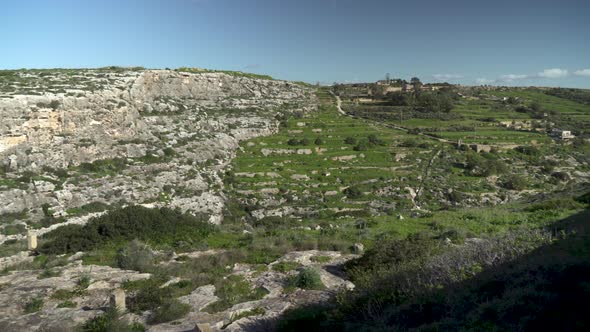 View of Magrr Ix-Xini Bay Canyon Steep Cliffs with Greenery in Gozo Island