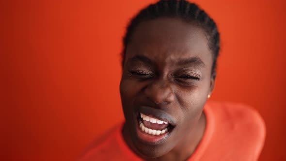 Happy blonde woman wearing yellow t-shirt typing by phone alt