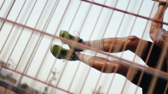 Street workout training. Shirtless man working out his arm muscles on outdoor gym as part of a worko alt