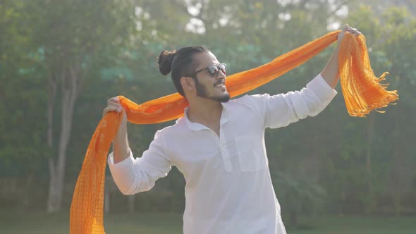 Indian man dancing openly in an Indian traditional outfit Kurta pajama alt