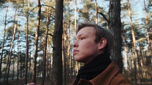 A Young Blond Male Photographer Takes Pictures of Nature alt