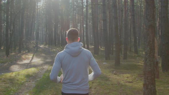 Man Is Jogging In Sunny Weekend Day