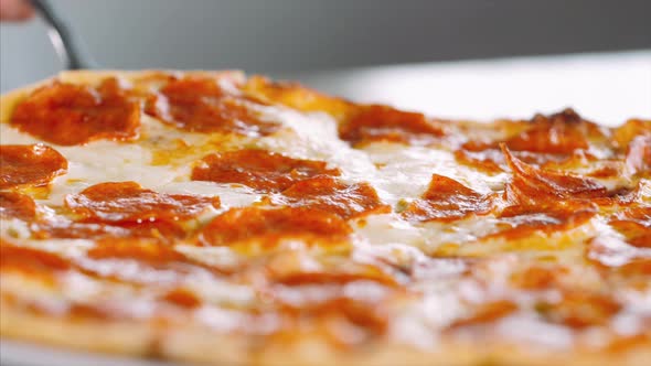 Taking Hot Pizza with Melted Stretching Cheese, Close-up.