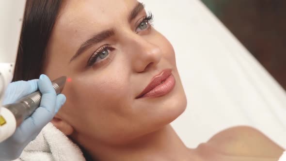 Woman Having Erbium Laser on Her Face at Spa alt