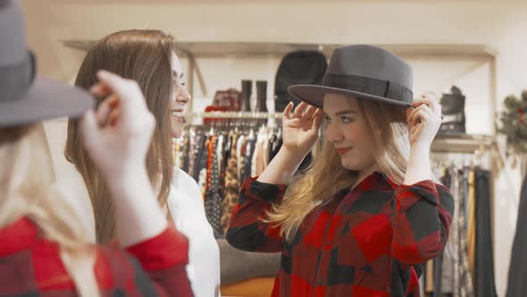 Female Friends Enjoying Shopping at Fashion Store Together