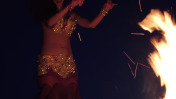 Night the Girl Dances Belly Dancing on the Sand, She Has a Bright Outfit alt