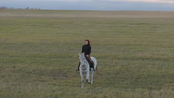 A Red-haired Woman Rides a White Horse
