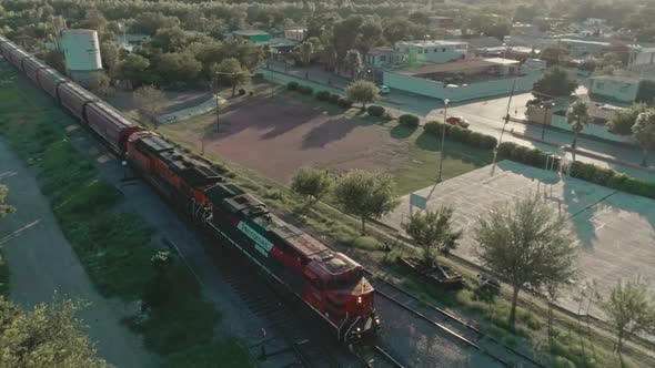 Aerial Of A Freight Train Passing Through Mexican northern Countryside alt