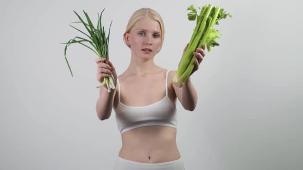 Pretty Young Woman Holding Green Leaves Recommending Vegan Natural Food alt