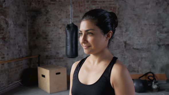 Young Indian Athletic Woman Resting After a Workout Takes a Breath Dressed in Sportswear  alt